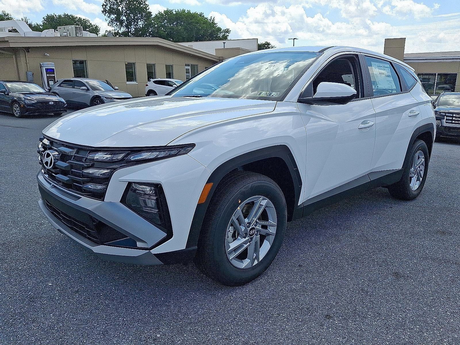 2026 Hyundai TUCSON SE AWD in Serenity White Pearl — front three-quarter view