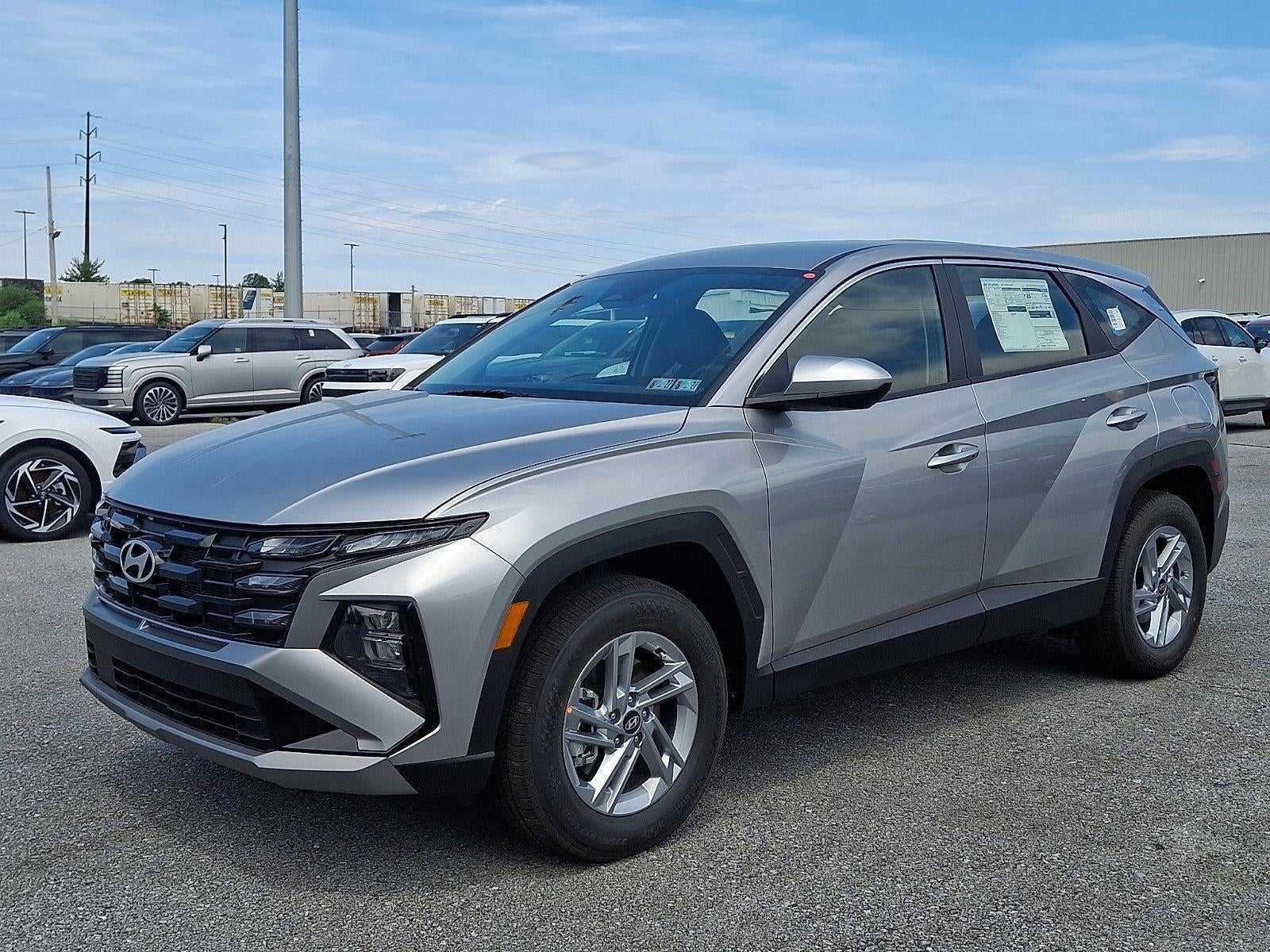 2026 Hyundai TUCSON SE AWD in Shimmering Silver — front three-quarter view
